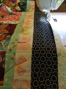 Sewing on the binding.