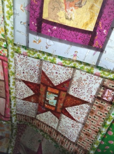 The quilt top held up to the window.